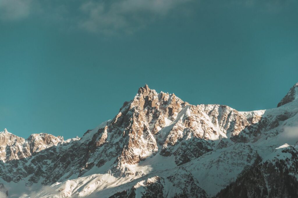 Scenic view of the snowcapped peaks of the French Alps with a vivid blue sky backdrop.